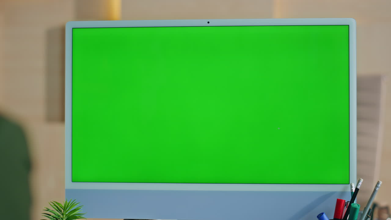 Green screen computer standing on work desk closeup. Woman looking chroma key pc