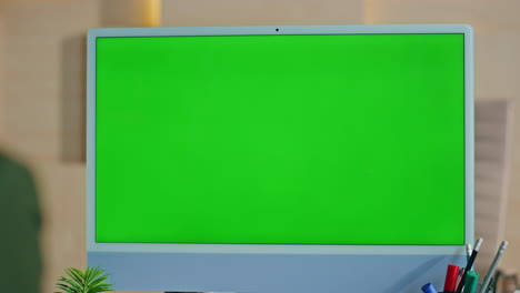 green screen computer standing on work desk closeup. woman looking chroma key pc
