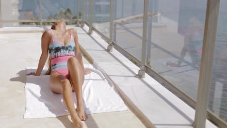 Charming-model-sunbathing-on-hotel-balcony