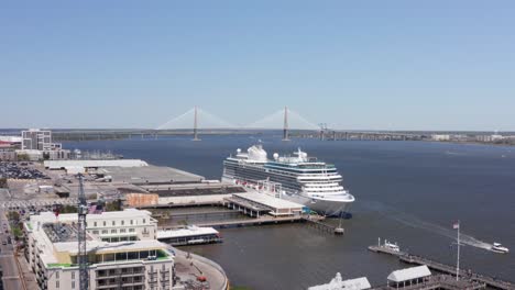 low aerial rising shot of the cruise terminal with the ravenel bridge in the distance in charleston, south carolina