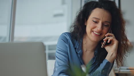 joyful worker discussing smartphone deal. closeup employee having conversation