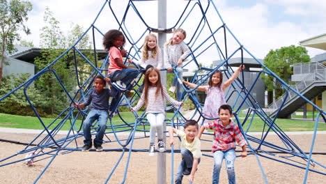 elementary school kids on climbing net in school playground