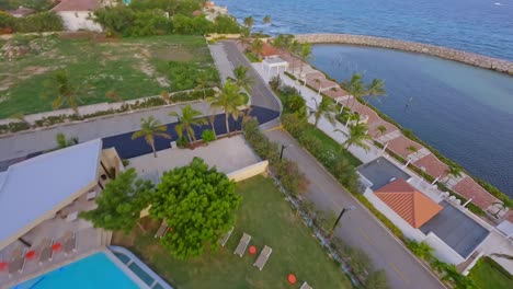 Acrobatic-drone-flying-over-Hotel-Hilton-Garden-Inn-of-La-Romana-in-Dominican-Republic-and-toward-beacon