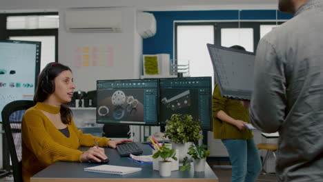 Woman-architect-engineer-taking-off-headset-talking-with-project-manager