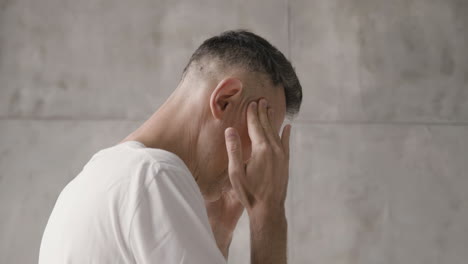 suffering man having a severe headache at home