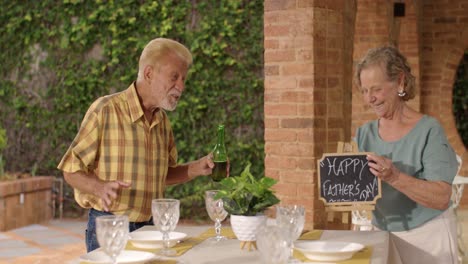 elderly couple celebrates father's day outdoors