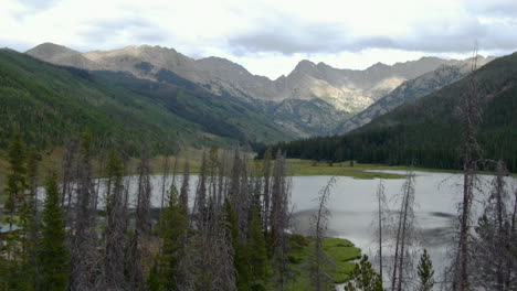 Aerial-cinematic-drone-Piney-Lake-Ranch-Vail-Beaver-Creek-Avon-Colorado-Gore-Range-mountain-landscape-late-summer-afternoon-rain-clouds-stunning-peaks-peaceful-calm-upwards-motion