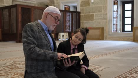 old man teaching quran