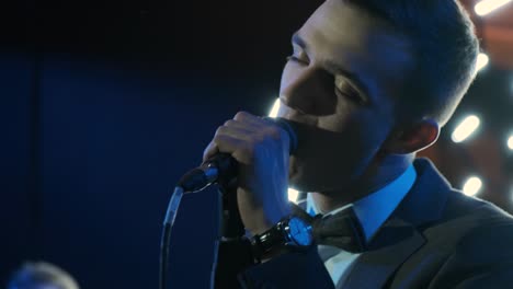 stylish group of young men musician or rock band playing on the stage in the club