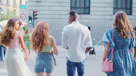 diverse group of people walking on a city street