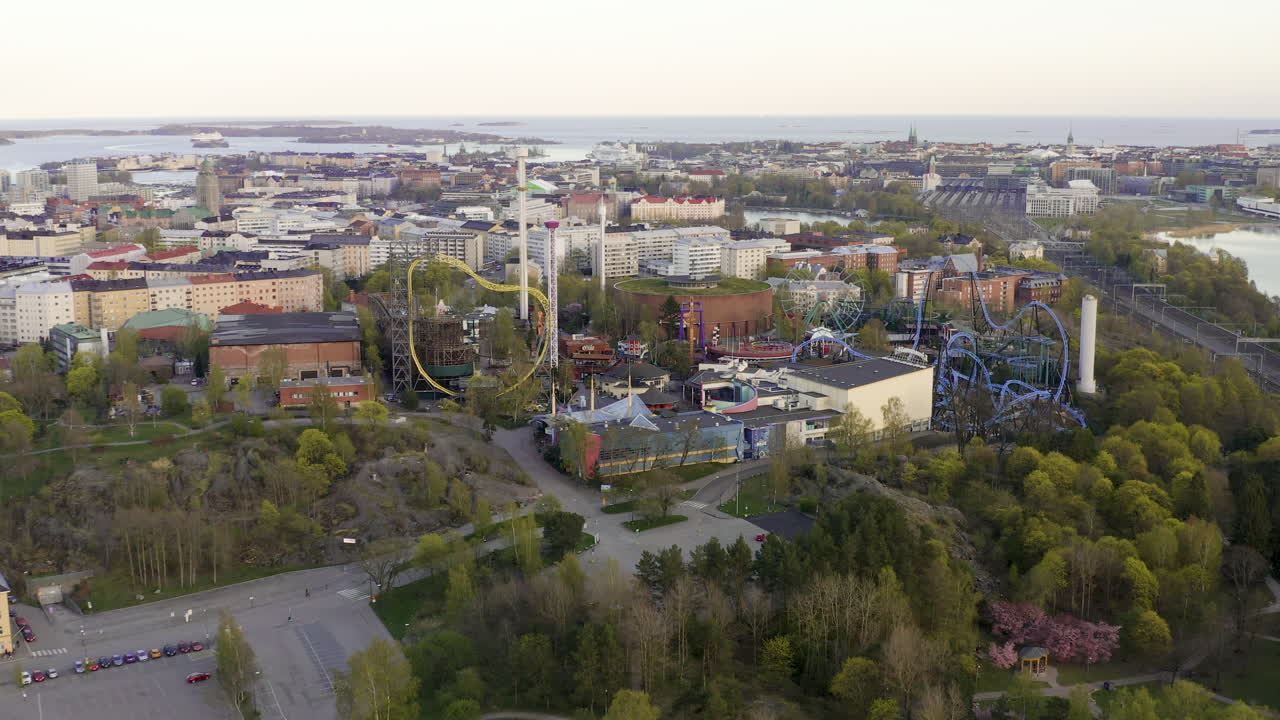 Aerial, drone shot, tilting towards the Linnanmaki amusement park, sunny, spring day, in Helsinki, Finland - Empty due to the Coronavirus