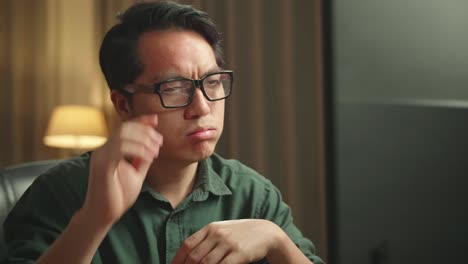 close up frustrated asian man working on personal computer and 3d printer
