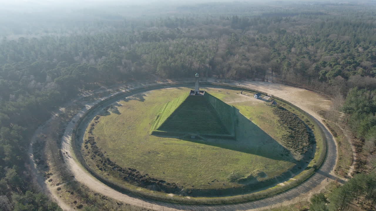 Stunning aerial of Austerlitz pyramid in the Netherlands. Drone flying backwards revealing beautiful forest. The Piramide van Austerlitz is a monument built in 1804 as a tribute to Napoleon Bonaparte.