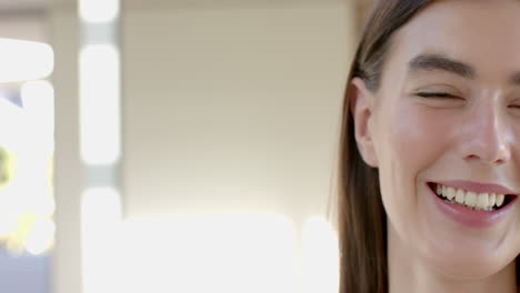 Close-up-of-a-smiling-teenage-Caucasian-girl-with-brown-hair,-with-copy-space,-at-home