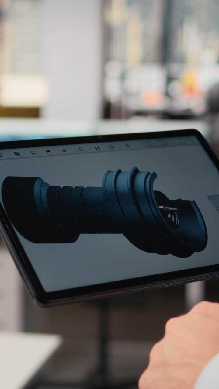 Close up of researcher analyzing turbine on tablet to maximize sustainability