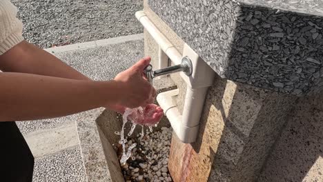 sequence of hands being washed under running water.