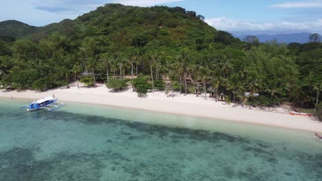 Holidaymaker-people-at-isolated-eco-friendly-resort-huts-on-tropical-Coco-beach-of-Bulalacao-island