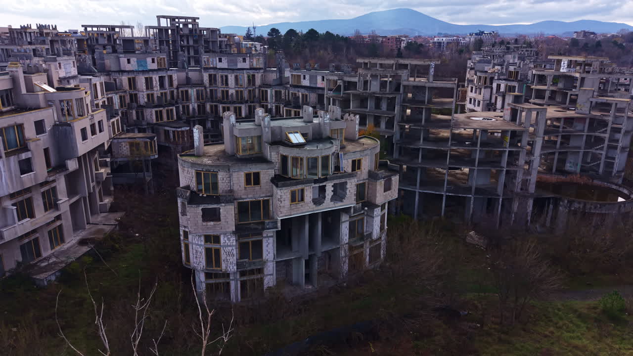 L'esplorazione urbana rivela la bellezza inquietante dell'architettura abbandonata, sullo sfondo di montagne lontane