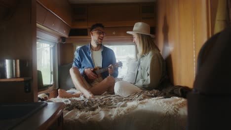 couple playing ukulele in rv