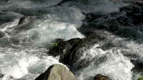 water stream flows through the stones, in slow motion