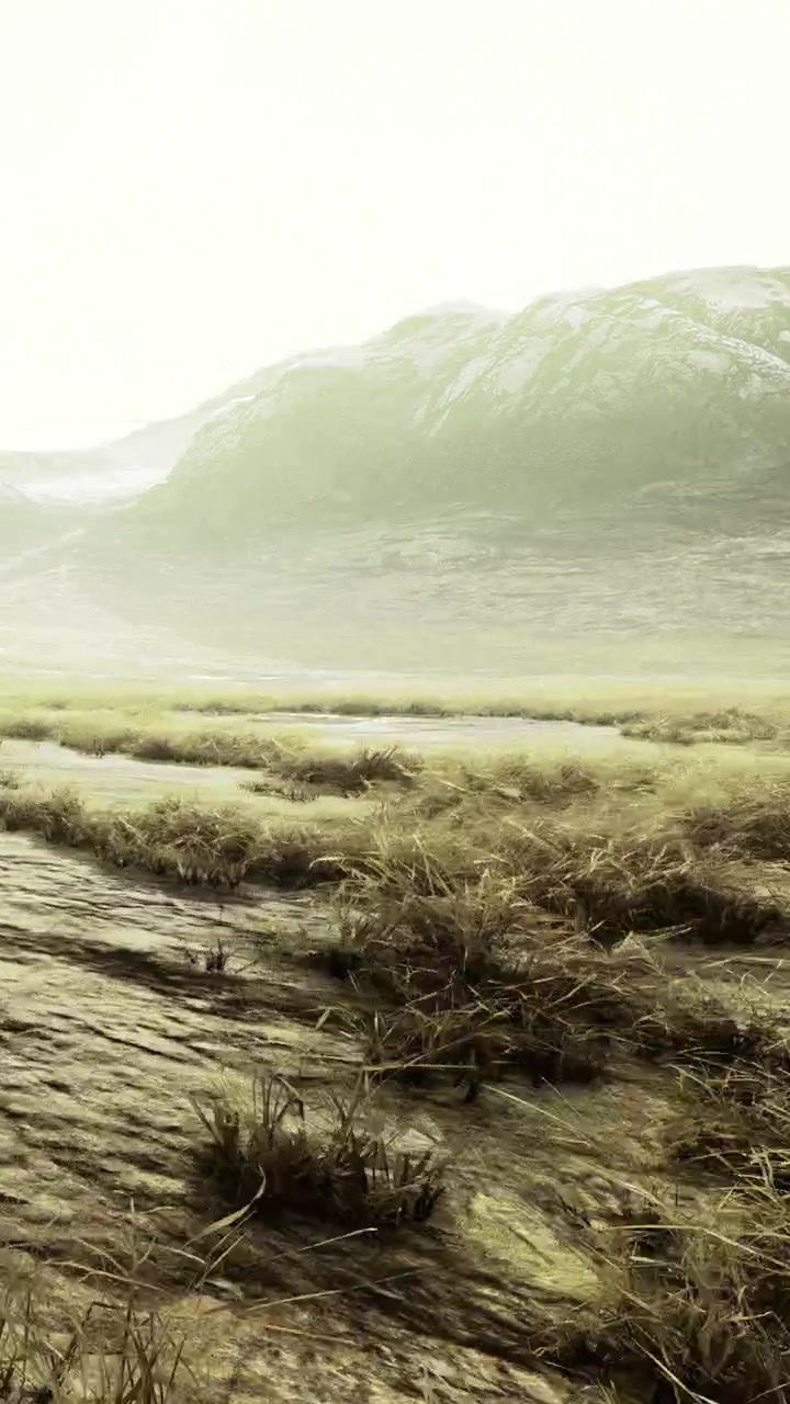 Scenic view of a grassy field and mountains under a cloudy sky
