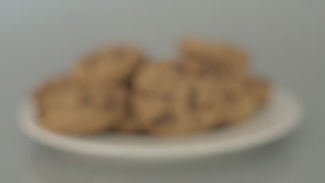 dolly in of pile of chocolate chip cookies - starting out of focus