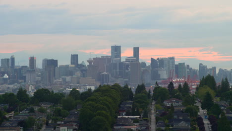 panorama of downtown with high rise buildings in vancouver harbour from burnaby, british columbia, canada at sunset