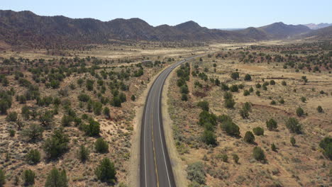 aerial view of interstate highway and cars during a road trip in the dry and rugged desert of utah in the american southwest