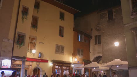 people exploring old town of annecy with buskers, local restaurants and shops in france. - tilt down shot