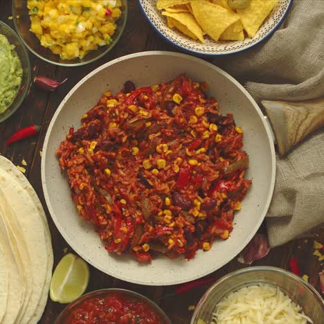 mexican food concept  vegetable burritos  served on pan  tortilla guacamole  salsa  chilli and beans