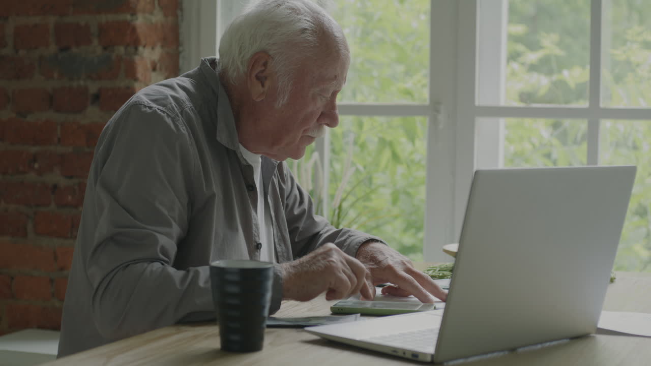 Senior Man Working on Laptop at Home