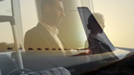 Airplane-against-businessman-sitting-in-airport-lounge