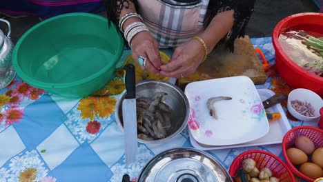 thai lady cleaning prawns for soup named tom yam kung