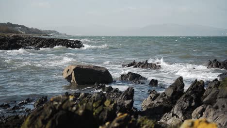 waves crashing on rocky shore, slow motion