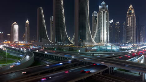 night view of modern city with skyscrapers and busy highway interchanges