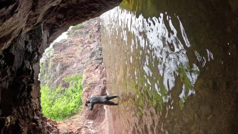 man swimming in wetsuit in lake superior