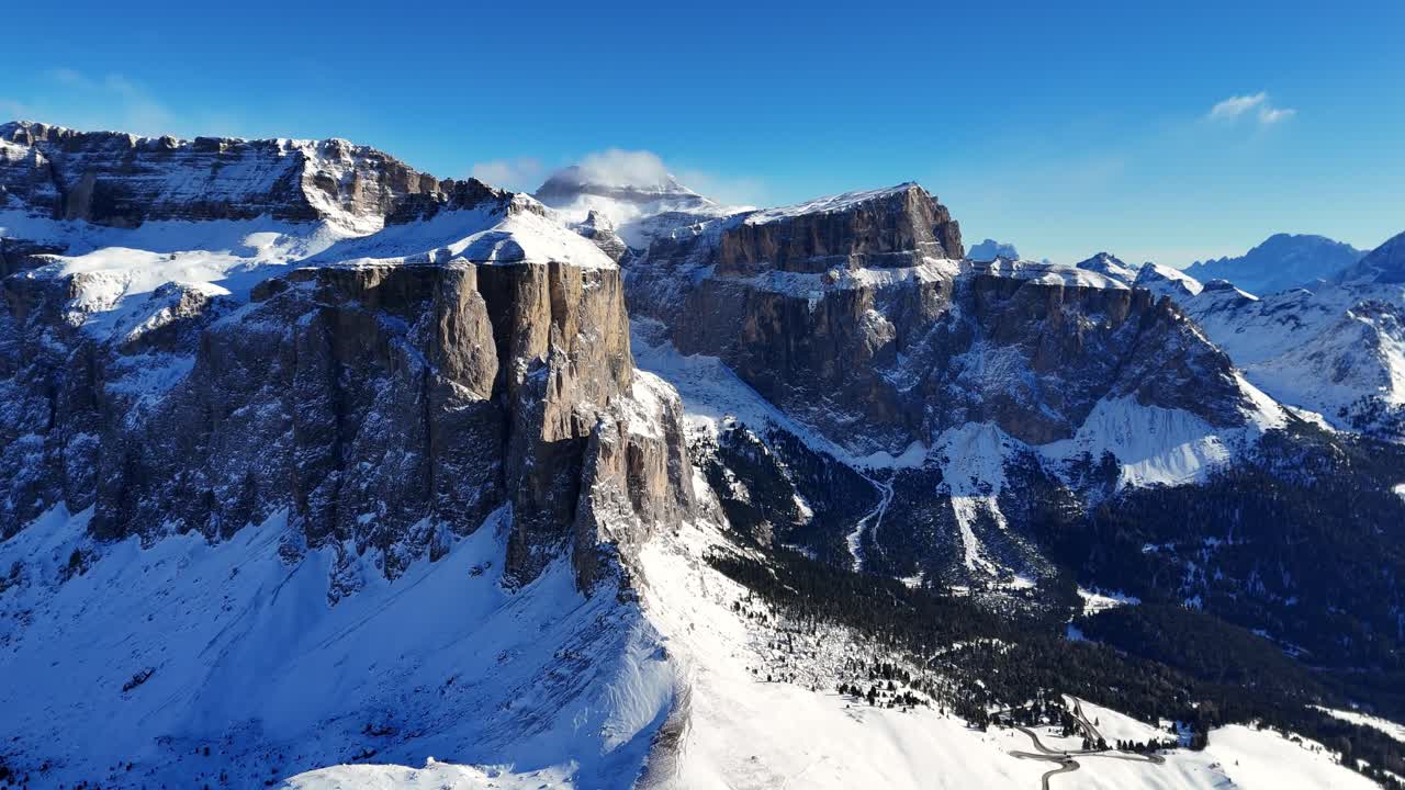 Dolomites outstanding rock formation covered with snow in winter season (drone footage)