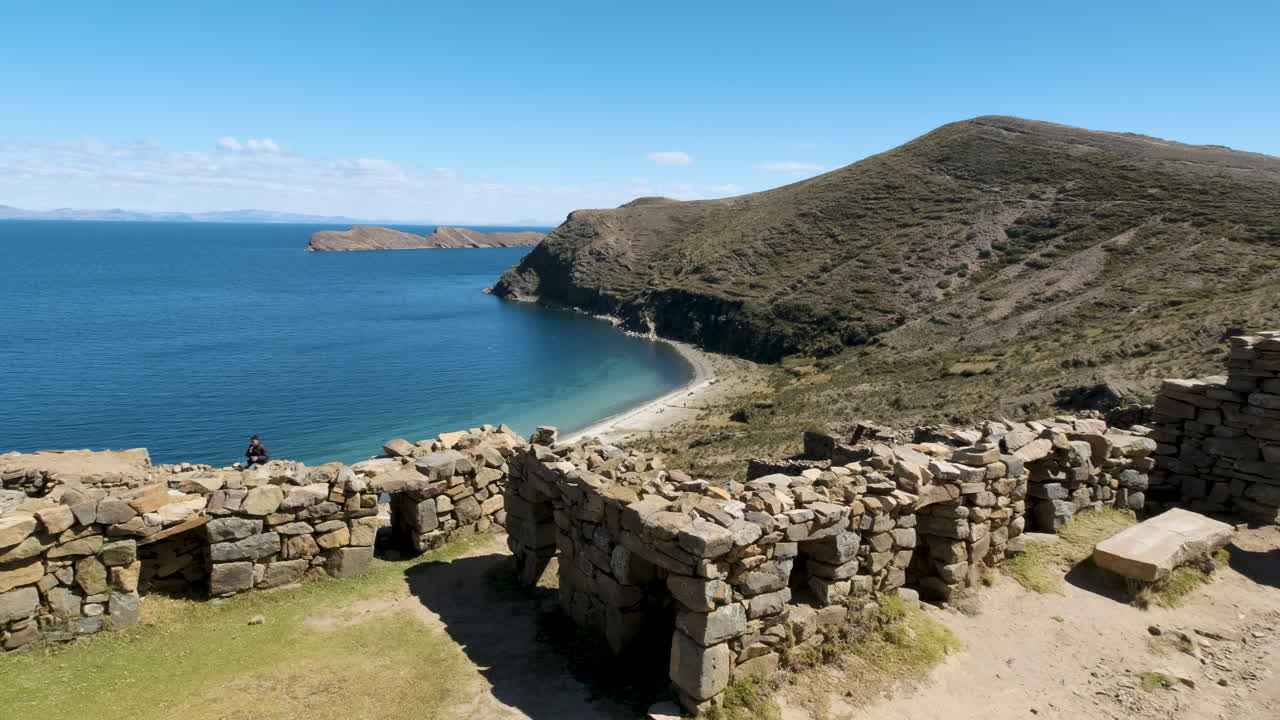 A sweeping pan shot showcases the mysterious Chincana Labyrinth on Isla del Sol, Copacabana, Bolivia. Highlights the ancient Inca ruins and the stunning views of Lake Titicaca