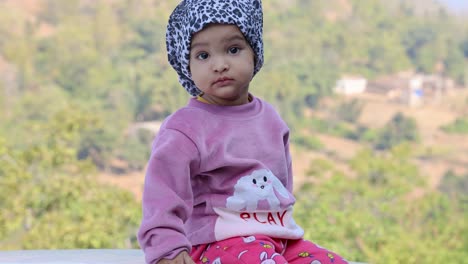 innocent child cute facial expression at outdoors at morning from flat angle