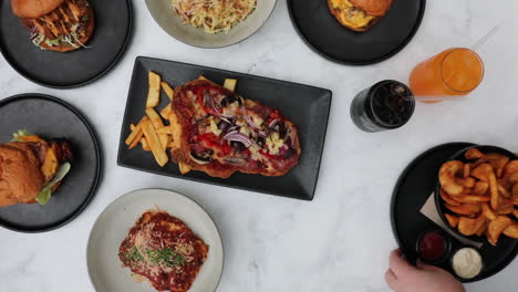 waiter picking up delicious hot wedges from lunch table feast setting