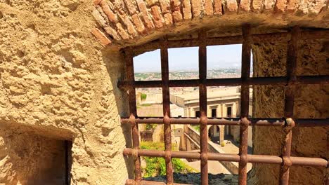 stone wall with barred windows in naples