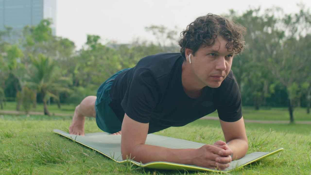 Man Doing Plank during Morning Workout in Park
