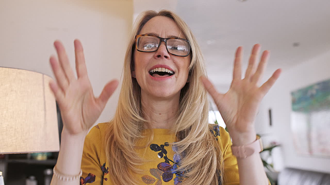 A woman with blonde hair and glasses