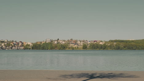 young skater girl crosses skating the screen, passing in front of a beautiful view of the river 1