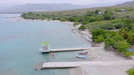 Jetty-and-empty-boats-on-beach-of-Bahia-de-Ocoa-Bay-in-Dominican-Republic