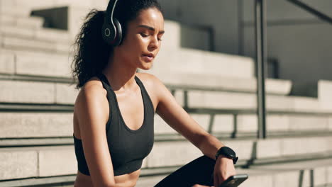 headphones, woman and phone on stairs for workout