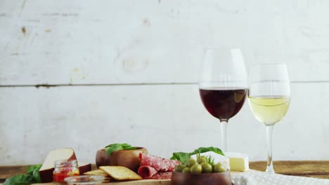 Wine-glasses-and-various-tapas-on-wooden-board