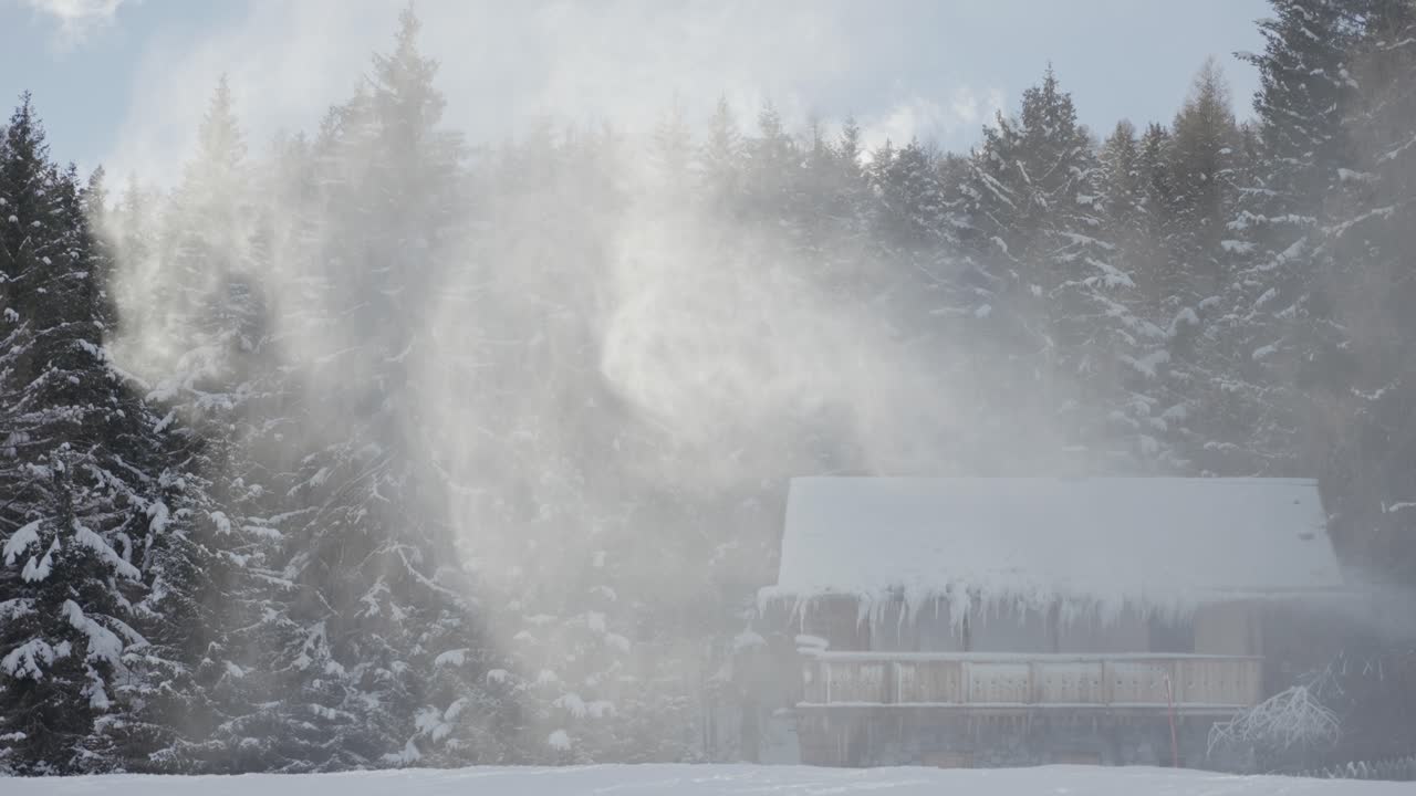 A rustic wooden cabin features heavy icicles and frosted wood beneath its snowy roofline as snow whirls around. Rapallax video.