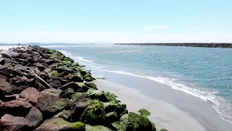 Drone-flies-over-rocky-beach