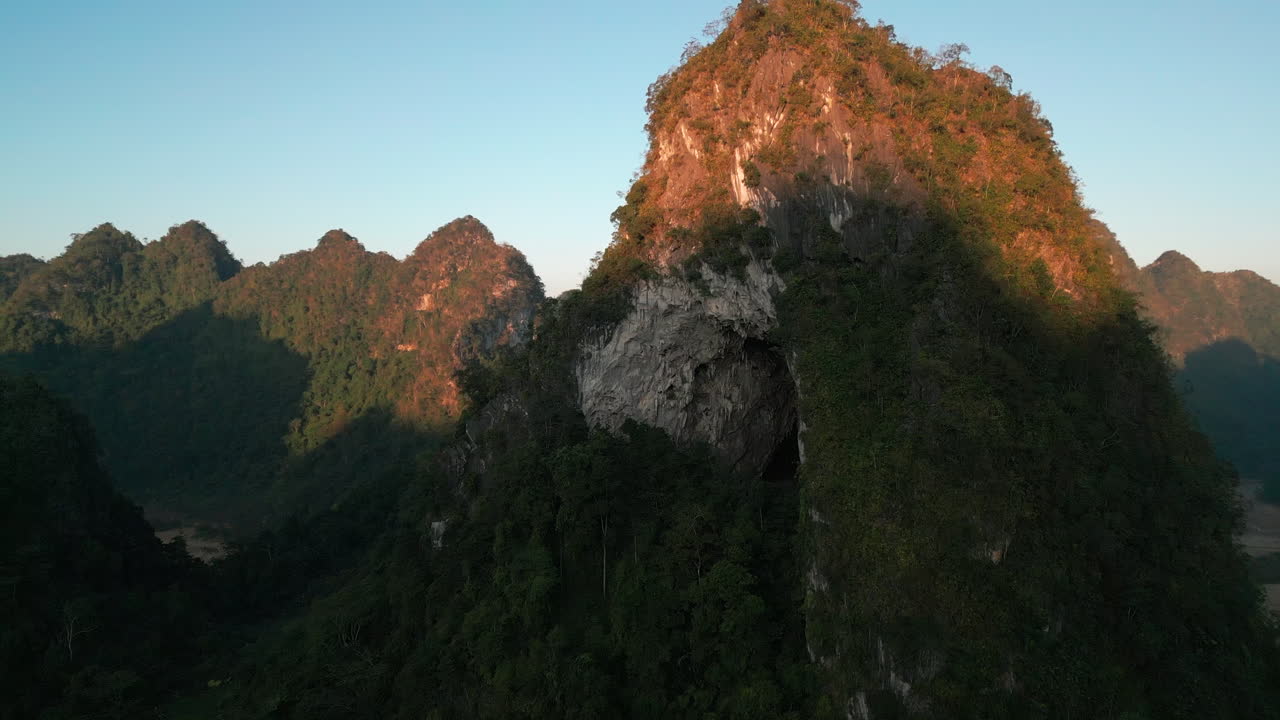 Stunning Aerial View of a Mountain with a Cave at Sunset